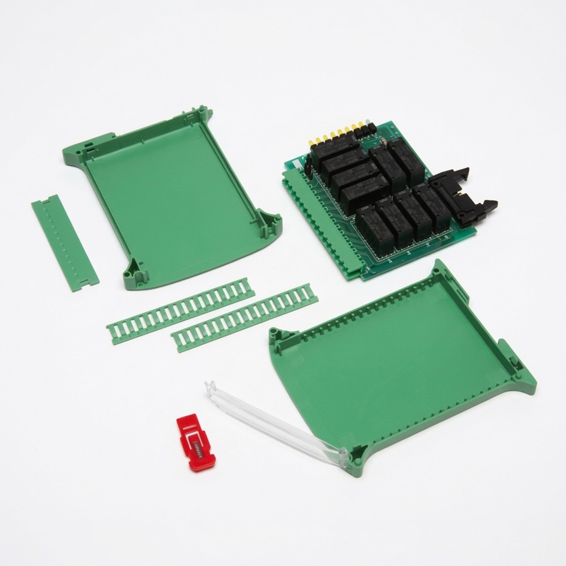Electronic components including green plastic boards and a red connector on a white background.